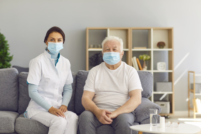 smiling woman and old man wearing facemask